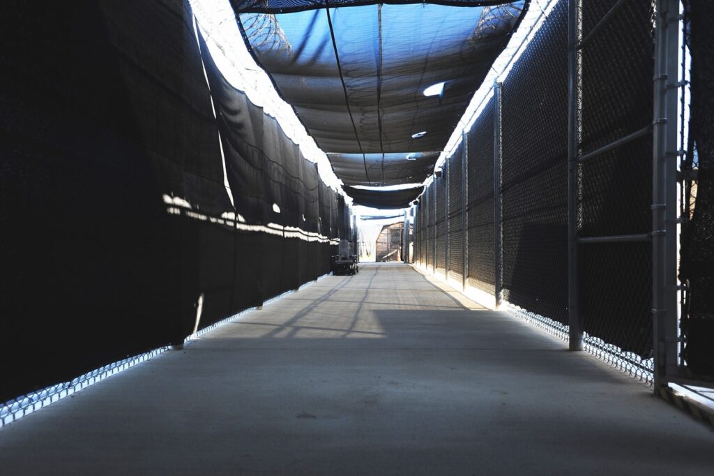 A screened, fenced walkway outside the Expeditionary Legal Complex at Guantanamo Bay, Cuba, where military commission hearings are held