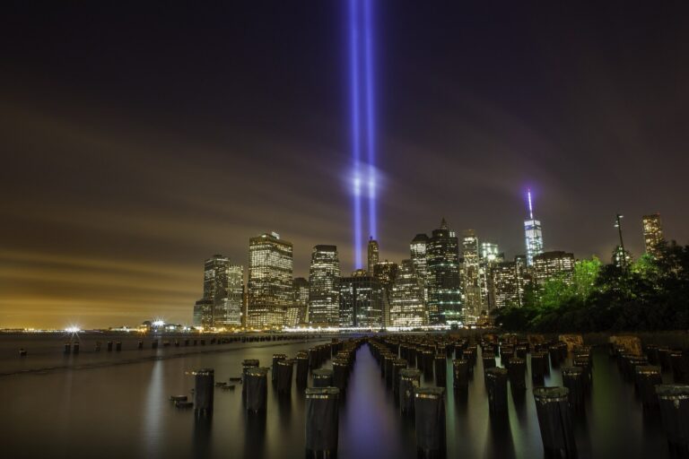 Twin beams of the Tribute in Light rise above the Lower Manhattan skyline at night