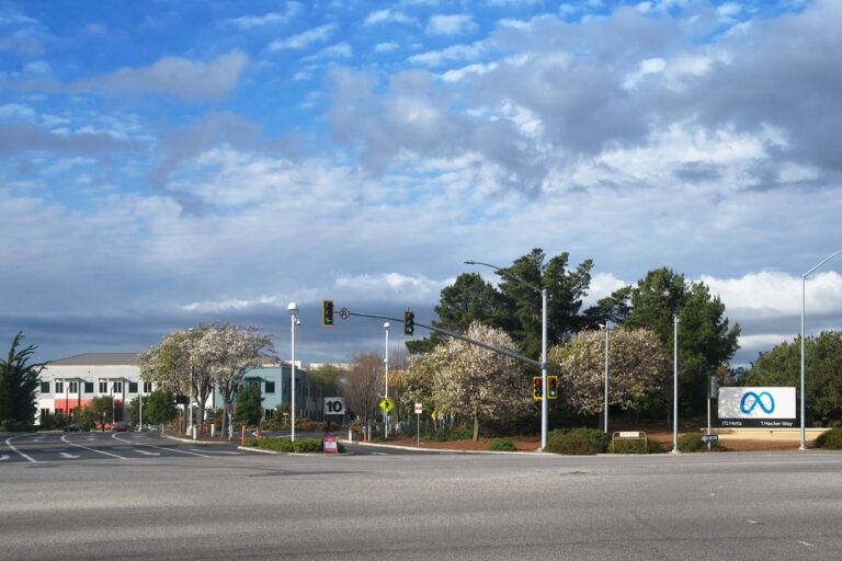 The entrance to Meta's headquarters campus in Menlo Park, California, under a partly cloudy sky