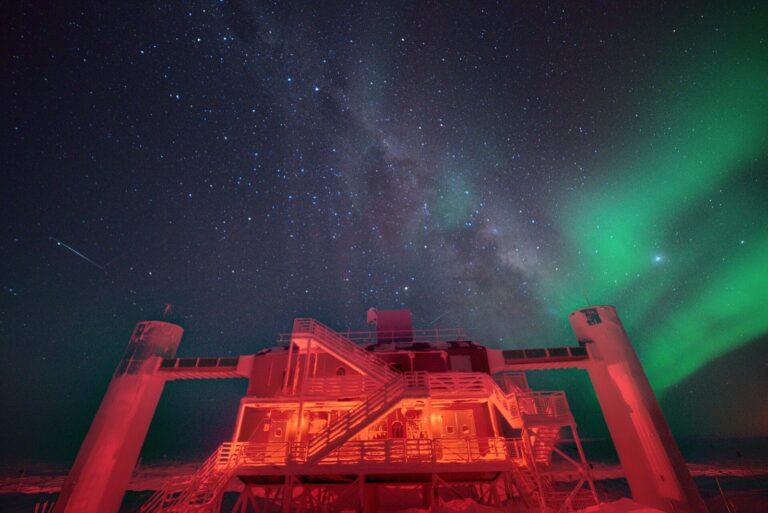 The IceCube Laboratory building at the South Pole under a dark winter sky
